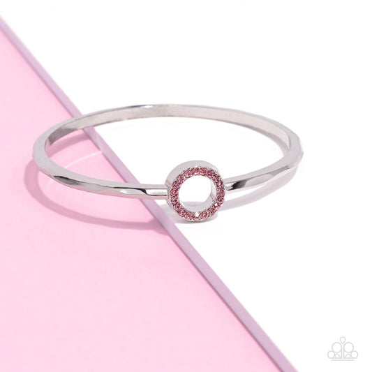 Center COUTURE - Pink and Silver Bracelet - Paparazzi Accessories - Brilliant dainty pink rhinestones set in a shiny silver round frame, create a glitzy circle in the center of a subtly hammered silver bangle. ﻿Sold as one individual bracelet.