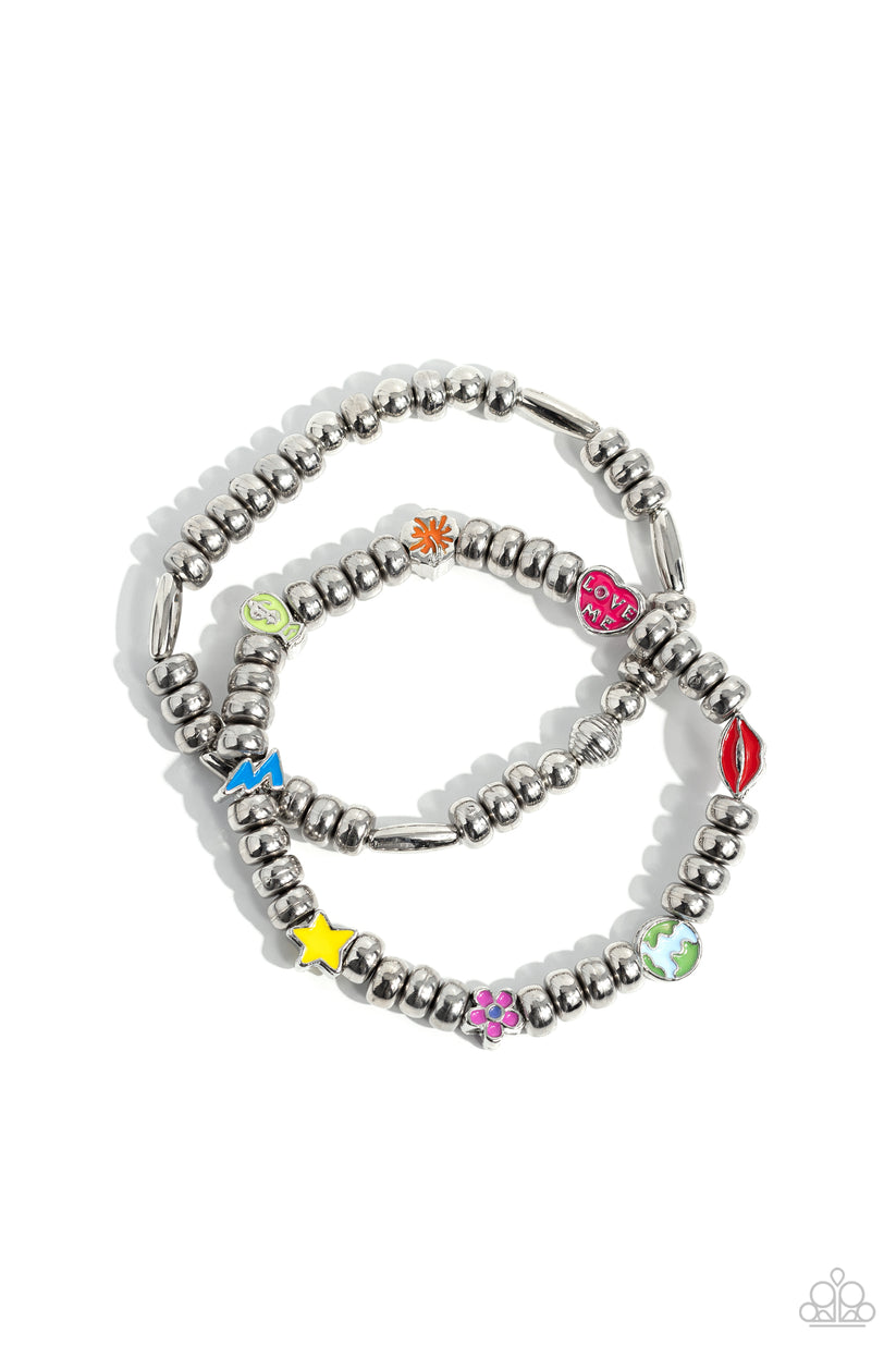 Charming Campaign - Multi Color Bracelet - Paparazzi Accessories - High-sheen silver beads combines with a single strand of silver beads, sporadically infused with vivacious charm beads to create an energetic stack of stretchy bracelets. The colorful beaded stack features a yellow star, blue lightning bolt, green money bag, orange tropical flower, red lips, blue and green earth, pink and purple flower, and a pink heart charm with the words "love me" for a youthful finish.
