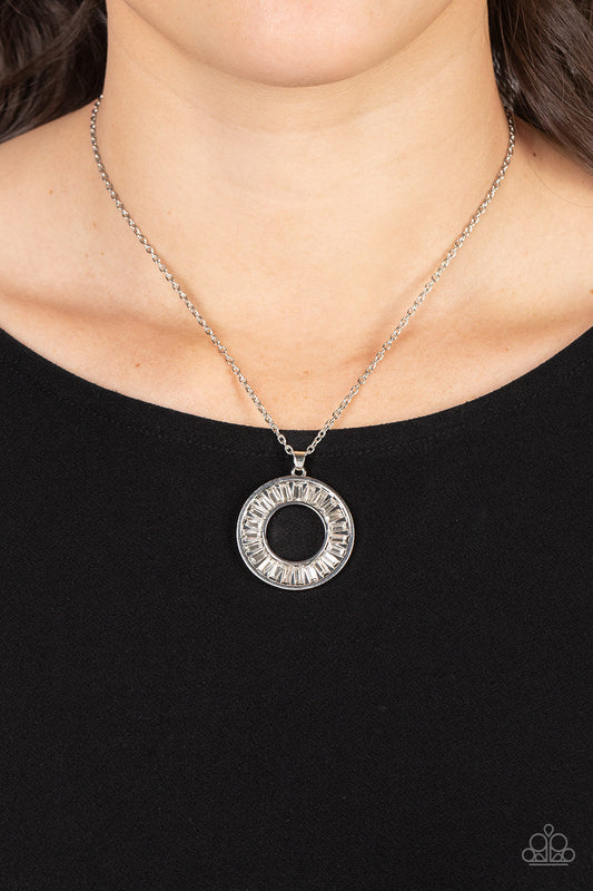 Clique Couture - White and Silver Necklace - Paparazzi Accessories - Brilliant emerald-cut rhinestones brushed in white shimmer are pressed inside a wide circular silver frame, creating a glitzy pendant at the bottom of a dainty silver chain.