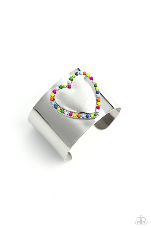 Cuffing Season - Multi Color Cuff Bracelet - Paparazzi Accessories - Featuring Rose Violet, light pink, Classic Green, Kohlrabi, Persian Jewel, Summer Song, High Visibility, red, and orange beads, the center of a thick silver cuff swoops and curls into a charming heart, creating a retro-inspired fashion.