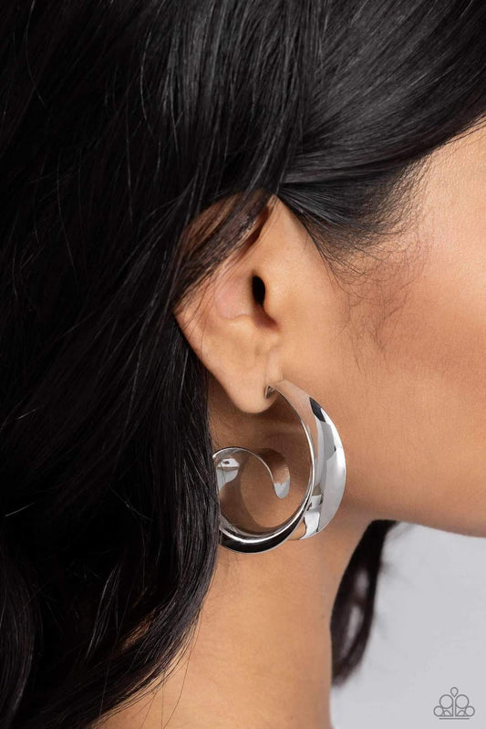 Curly Cadence - Silver Hoop Earrings - Paparazzi Accessories - Featuring a sleek finish, a thick band of silver curls into a dainty swirl at the bottom of the ear for an eye-catching centerpiece. Earring attaches to a standard post fitting. Hoop measures approximately 1 1/2" in diameter.
