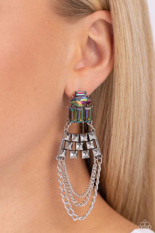 Dangling Art Deco - Multi Color - Oil Spill Earrings - Paparazzi Accessories - Featuring silver pronged fittings, a collection of emerald-cut and marquise-cut oil spill beads layer atop one another, connecting to a haphazard pattern of silver squares that come to a point. Mismatched silver chains swing from the bottom of the spiked silver fittings, creating an edgy art-deco-inspired chandelier.