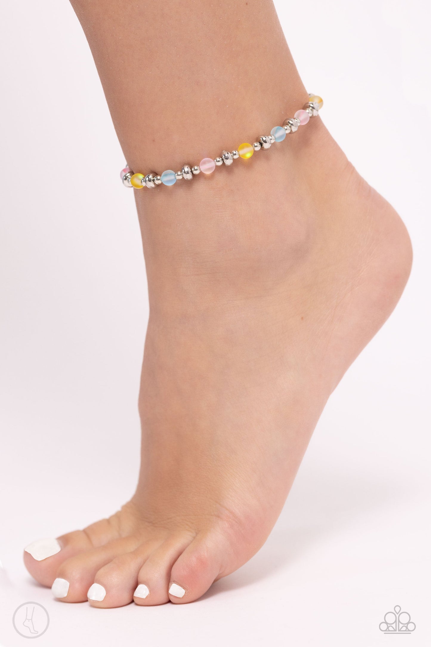 DEW or Die - Multi Color Ankle Bracelet - Paparazzi Accessories - Infused with dainty silver accents, a collection of blue, yellow, and pink reflective beads are threaded along an invisible band around the ankle for a seasonal finish. Sold as one individual anklet.