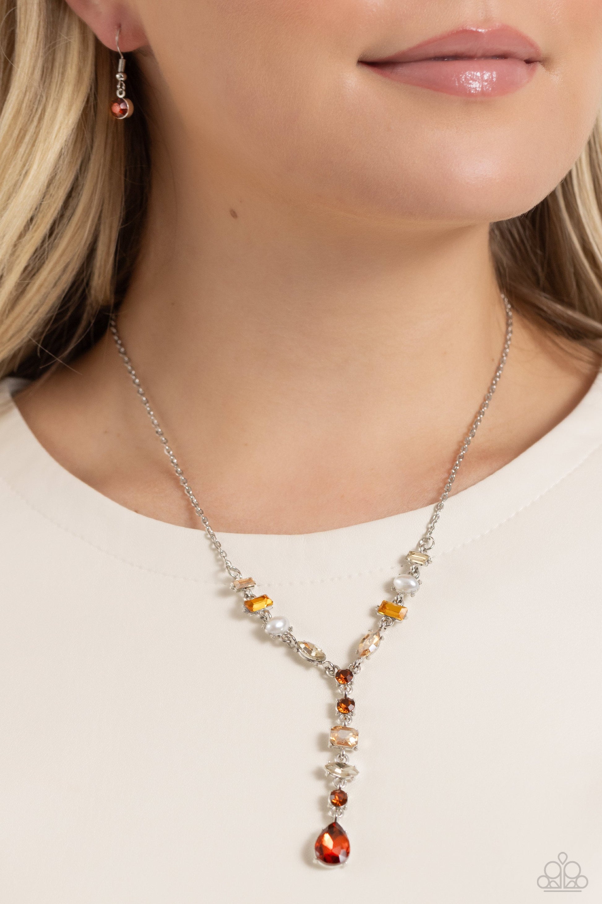 Dreamy Dowry - Topaz Brown Necklace - Paparazzi Accessories - Mismatched polished white pearls and various glassy topaz, light colored topaz, and champagne gems dance along a shimmery dainty silver chain. Matching gems trickle along a single silver chain with an exaggerated topaz gem teardrop at the bottom of the design, creating an extended pendant below the collar.