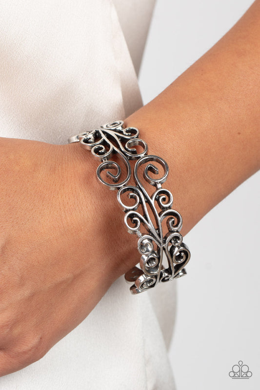 Dressed to FRILL - Silver Bracelet - Paparazzi Accessories - Frilly silver vine-like filigree scrolls around the wrist, coalescing into a whimsical bangle-like bracelet. Features a hinged closure. Sold as one individual bracelet.