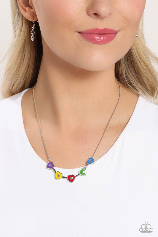 ECLECTIC Heart - Multi Color Necklace - Paparazzi Accessories - Strung along a dainty silver chain, a collection of silver heart frames, and silver bars alternate for a dainty display around the collar. Each heart is painted in a French Blue, Classic Green, red, High Visibility, and purple hue with dainty silver hearts glistening at their centers for a pop of colorful detail.