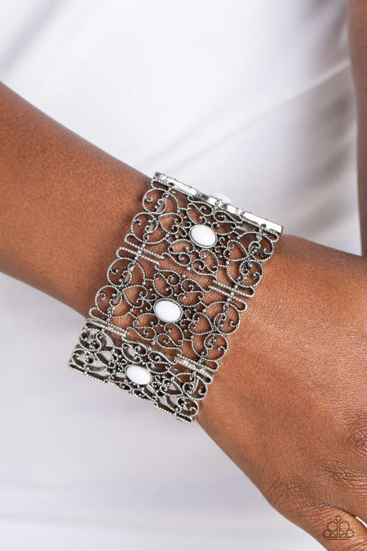 Fairest Filigree - White and Silver Bracelet - Paparazzi Accessories - Shiny white beads, set in vertical, rectangular frames of swirling silver filigree are infused along stretchy bands for a whimsically wild fashion around the wrist.