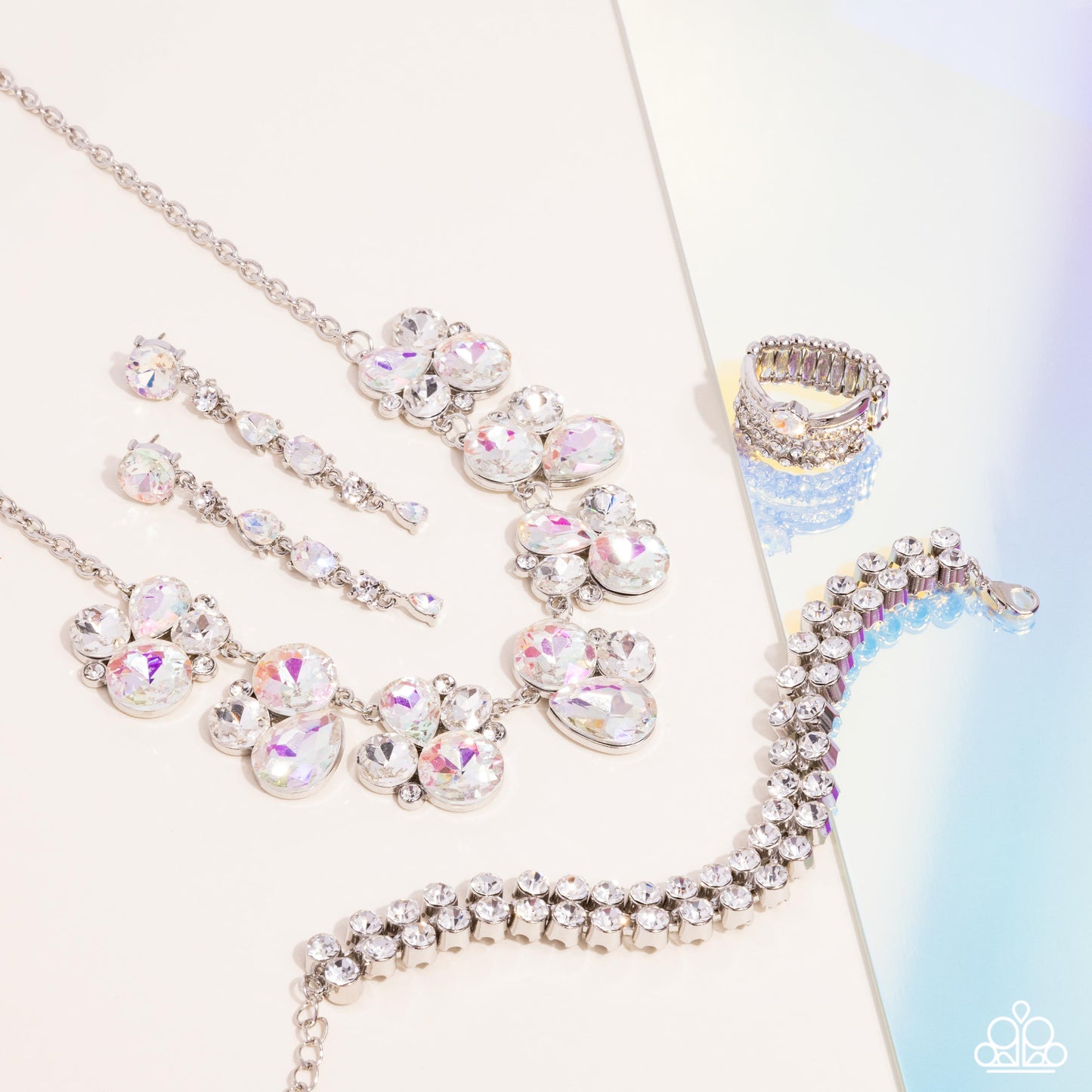 Fiercely 5th Avenue - Iridescent Jewelry Set - Paparazzi Accessories - Includes one of each accessory featured in the Fiercely 5th Avenue Trend Blend in April's Fashion Fix: Fairytale Frost - White Necklace, Fairytale Falls - White Post Earrings, Once Upon A TIARA - White​ Bracelet, and Her Royal Highness White Ring.