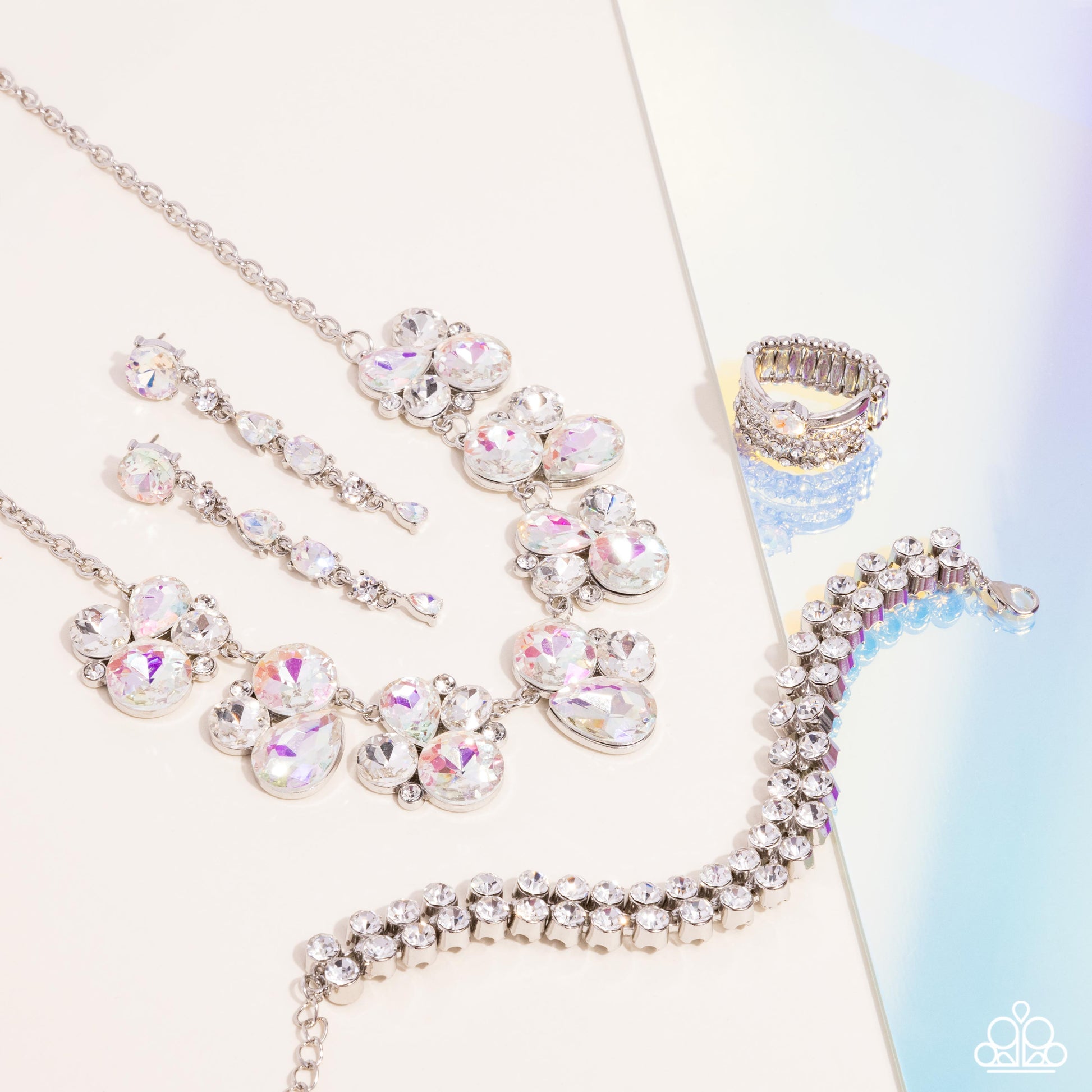 Fiercely 5th Avenue - Iridescent Jewelry Set - Paparazzi Accessories - Includes one of each accessory featured in the Fiercely 5th Avenue Trend Blend in April's Fashion Fix: Fairytale Frost - White Necklace, Fairytale Falls - White Post Earrings, Once Upon A TIARA - White​ Bracelet, and Her Royal Highness White Ring.