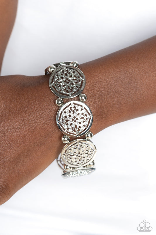 Filigree Fanfare - Silver Bracelet - Paparazzi Accessories - Filled with shiny floral-like filigree, a collection of glistening silver discs links around the wrist on a stretchy band for a whimsical fashion. Silver beads separate each floral display for additional high-sheen shimmer.