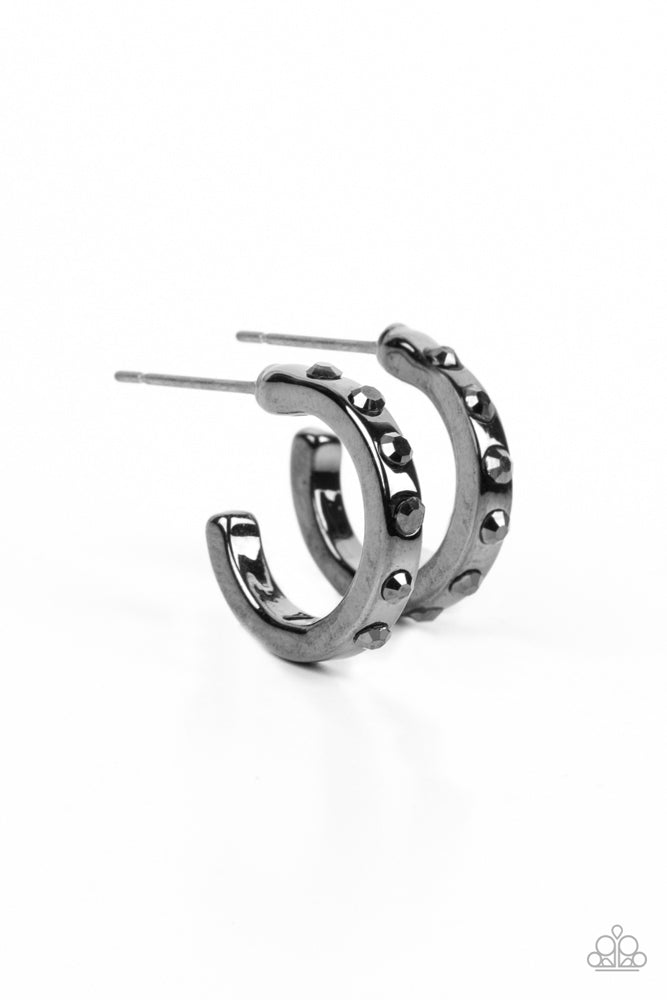 Gallant Glitz - Black Gunmetal Hoop Earrings - Paparazzi Accessories - The front edge of a shiny gunmetal hoop is decorated in a sparkly collection of tiny hematite rhinestones for a gritty finish. Earring attaches to a standard post fitting. Hoop measures approximately 1/2" in diameter. Sold as one pair of hoop earrings.