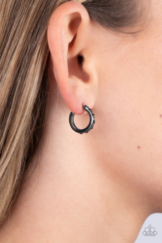 Gallant Glitz - Black Gunmetal Hoop Earrings - Paparazzi Accessories - The front edge of a shiny gunmetal hoop is decorated in a sparkly collection of tiny hematite rhinestones for a gritty finish. Earring attaches to a standard post fitting. Hoop measures approximately 1/2" in diameter. Sold as one pair of hoop earrings.