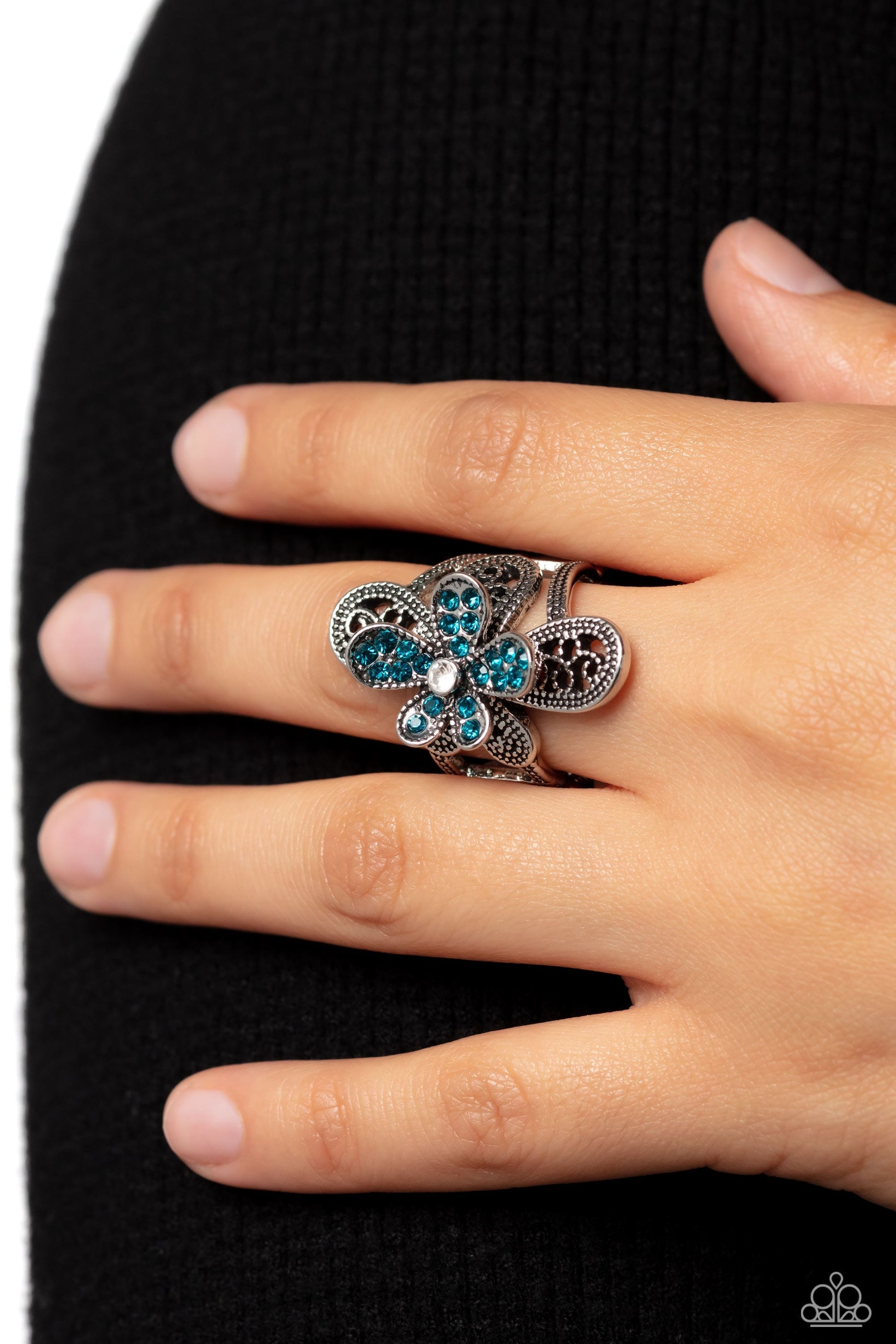 Garden Escapade - Blue Ring - Paparazzi Accessories - Dotted with a dainty white rhinestone center, silver petals overlaid with glittery blue rhinestones, sit atop studded silver filigree petals, creating a frilly floral centerpiece atop the finger.