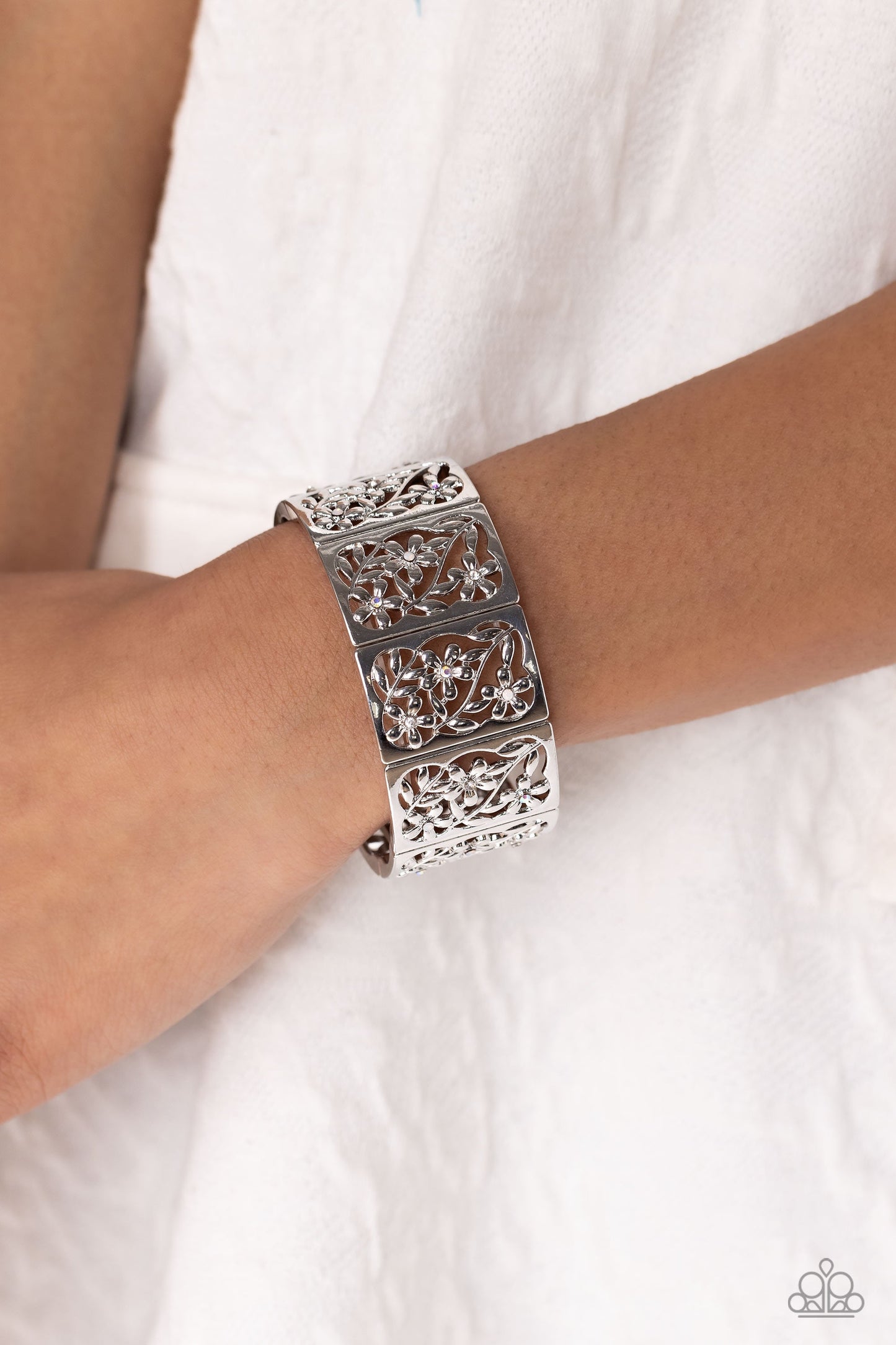 Garden Walls - White Iridescent and Silver Bracelet - Paparazzi Accessories - Sleek silver frames, filled with whimsical leafy floral filigree and opalescent, white, and iridescent rhinestones, stack around the wrist on an elastic stretchy band for a dainty handcrafted statement.