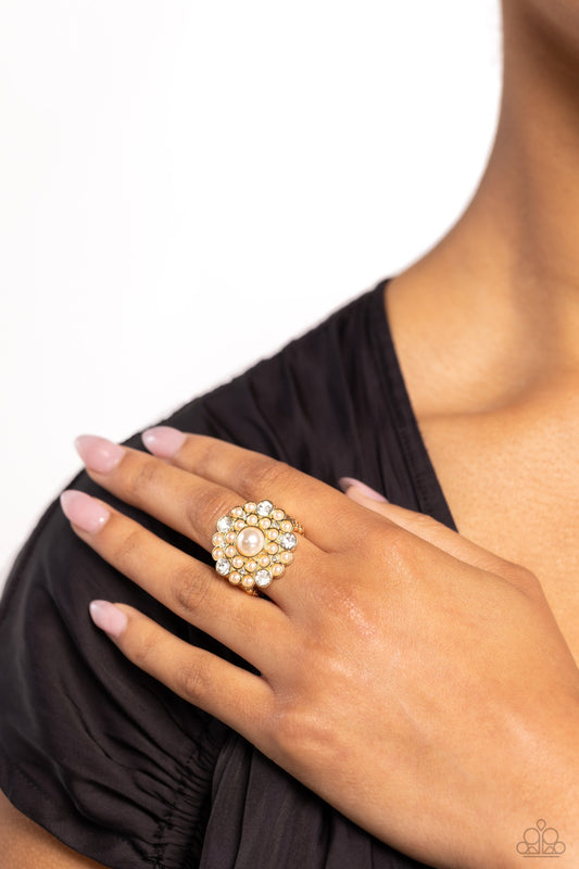 Gatsby Gait - Gold Pearl Ring - Paparazzi Accessories - An explosion of white gems and dainty glossy white pearls encircle a larger white pearl center, creating a glamorous gold centerpiece atop the finger.