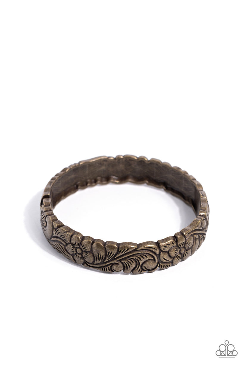 Grounded Grace - Brass Bracelet - Paparazzi Accessories - A brass bangle-like bracelet embellished with floral and botanical detailing encircles the wrist for a whimsical flair. Features a hinged closure. Sold as one individual bracelet.