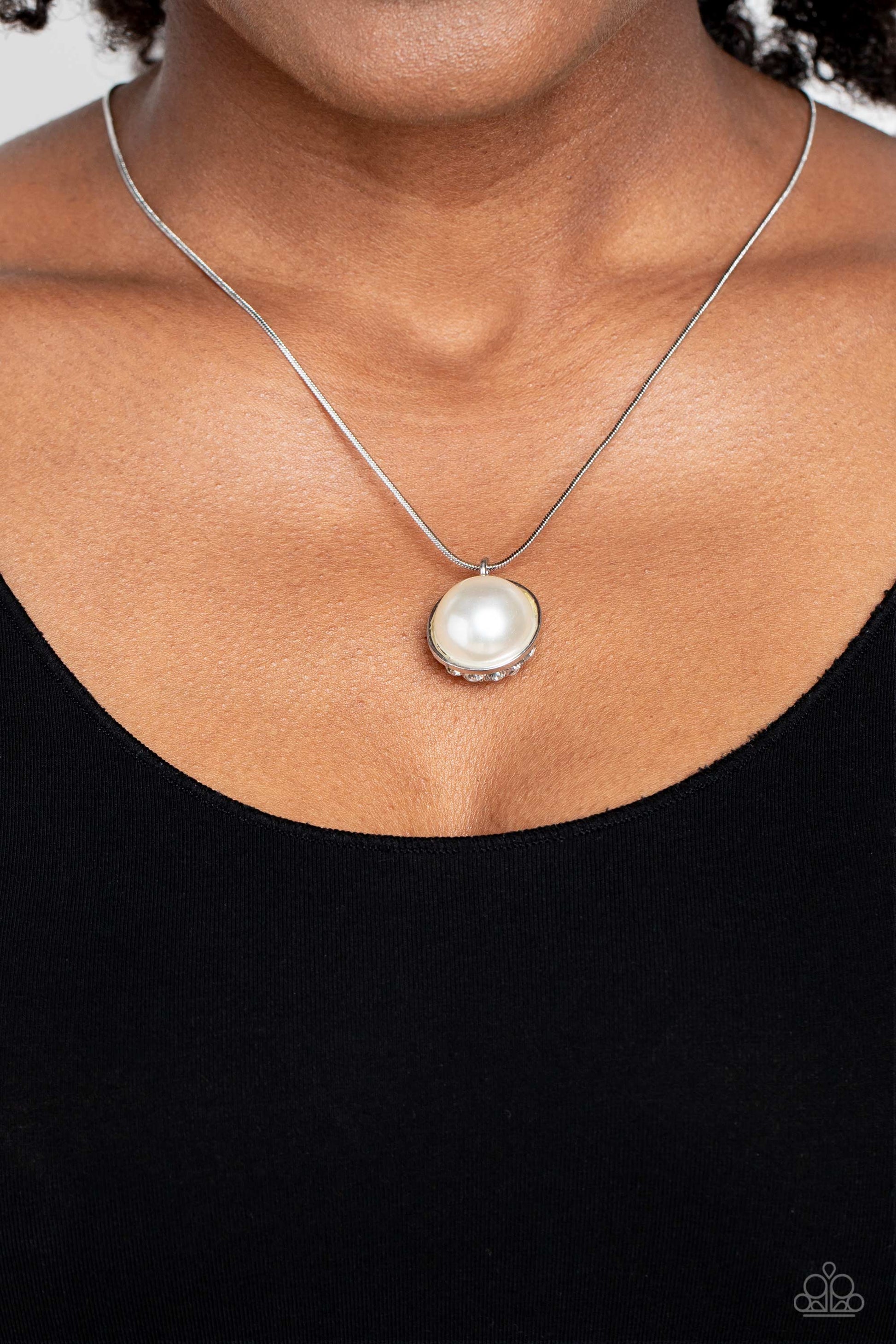 Haute Hybrid - White Pearl and Silver Necklace - Paparazzi Accessories - Cascading from a shiny silver snake chain, a sparkly white rhinestone-encrusted ornament and a classic white pearl meet to create a half-and-half refined pendant. 