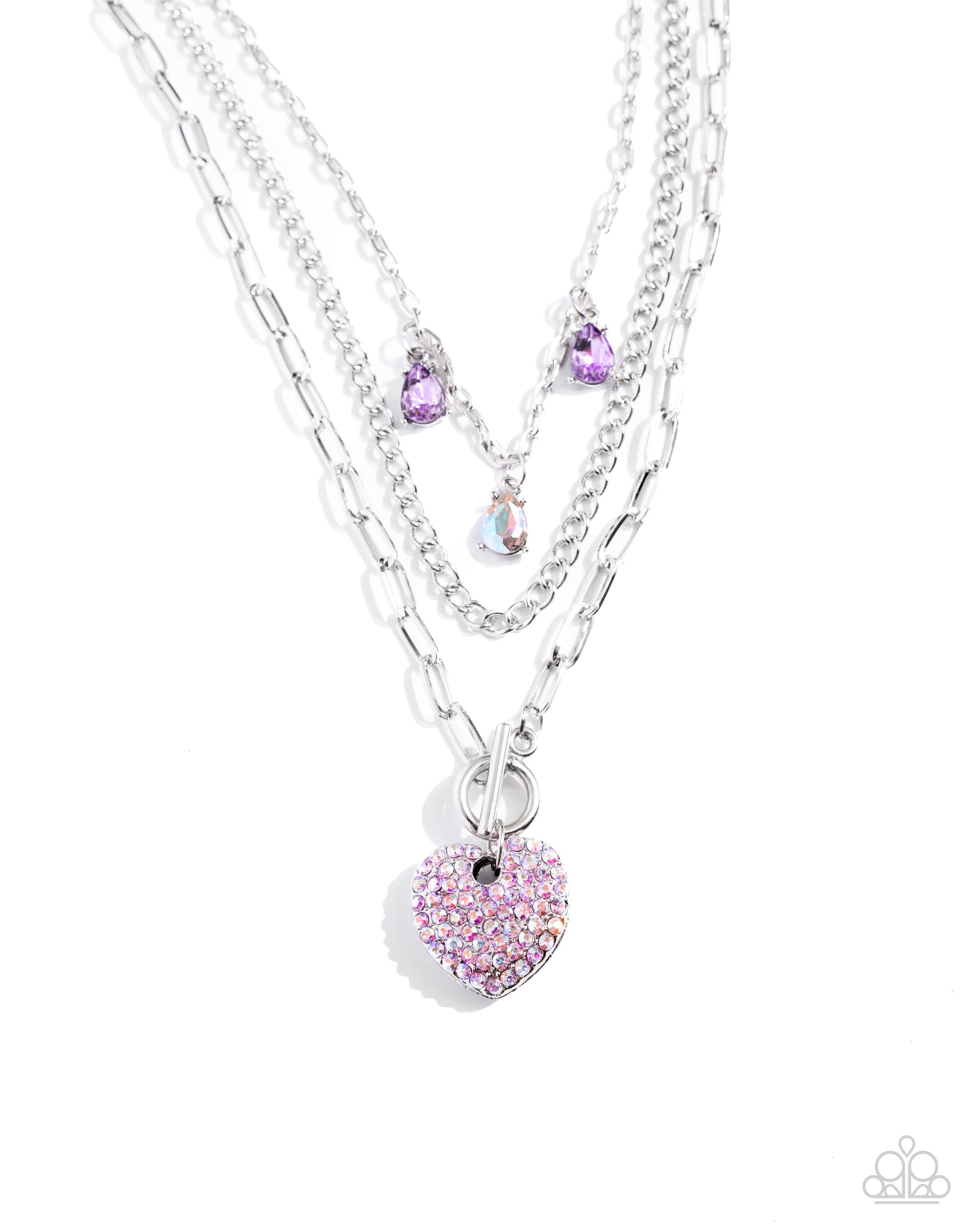 HEART History - Purple Necklace - Paparazzi Accessories - Three mismatched silver chains layer and loop around the neckline. Two purple and an iridescent teardrop gem in silver-pronged fittings dangle from the uppermost chain while a lavender iridescent-rhinestone encrusted heart pendant loops through the lowermost chain for a radiantly, romantic statement.