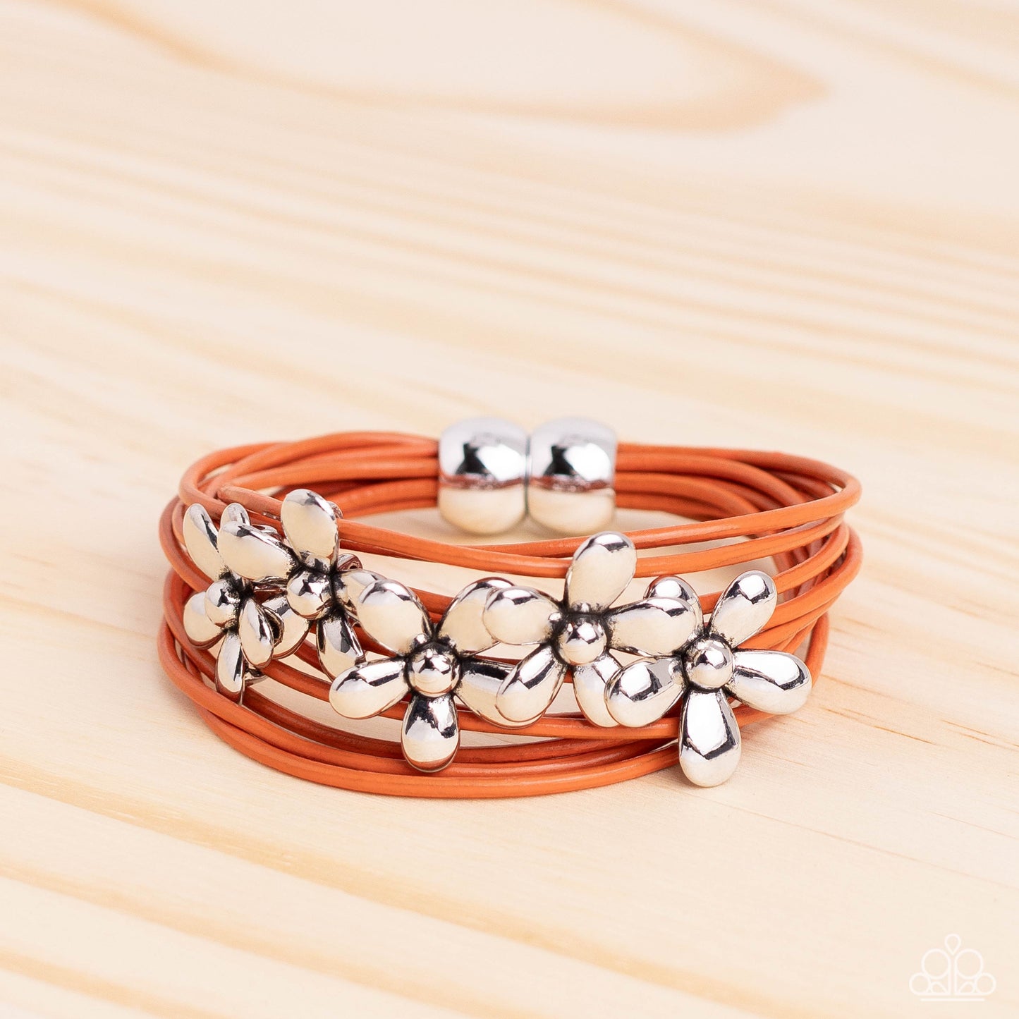 Here Comes the BLOOM - Orange Bracelet - Paparazzi Accessories - Shiny silver flowers glide along leathery burnt orange cords, clustering into a shimmery floral statement piece at the center of the wrist.