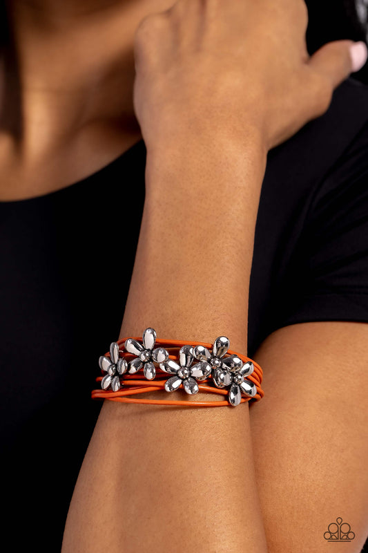 Here Comes the BLOOM - Orange Bracelet - Paparazzi Accessories - Shiny silver flowers glide along leathery burnt orange cords, clustering into a shimmery floral statement piece at the center of the wrist.