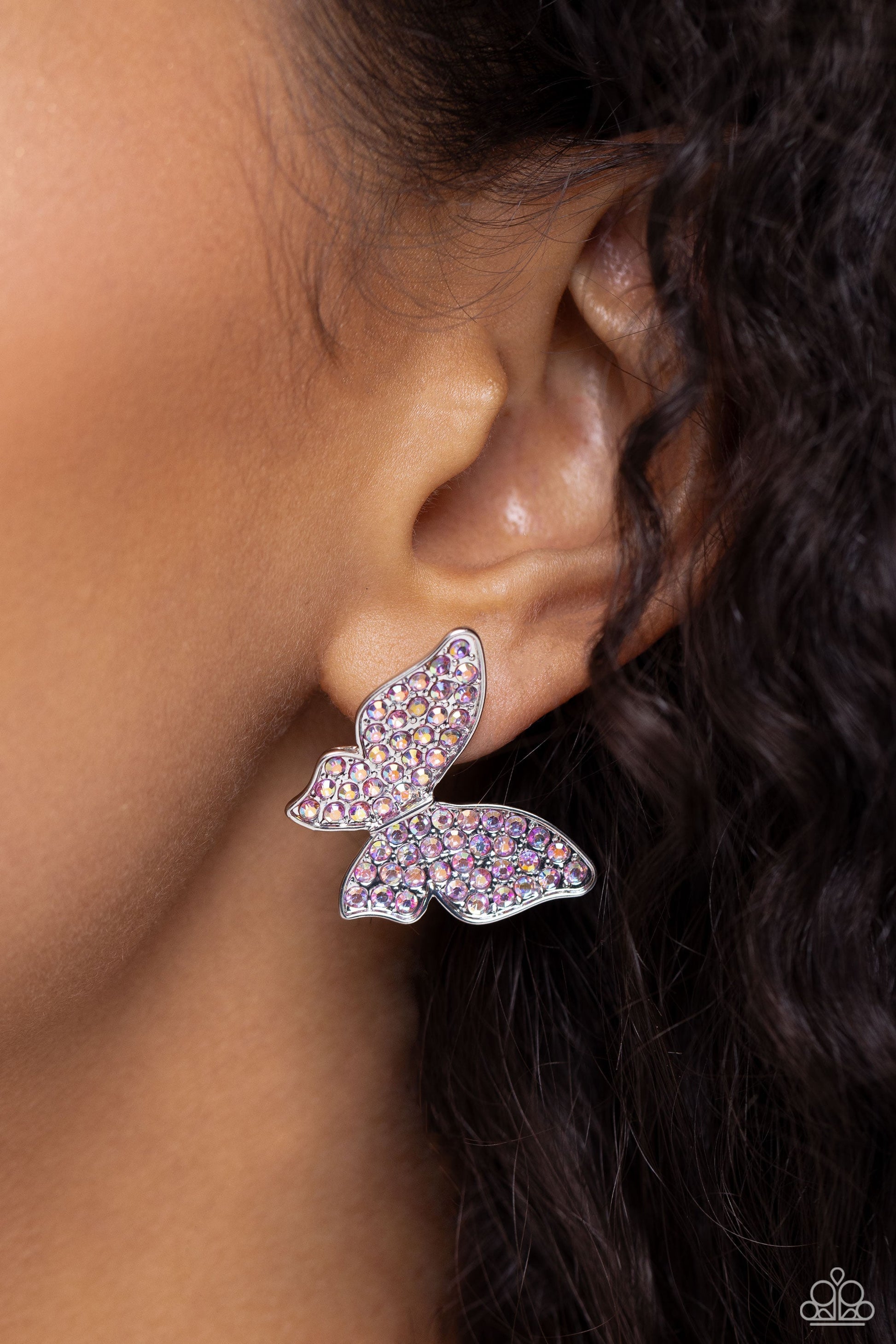 High Life - Pink Butterfly Earrings - Paparazzi Accessories - Featuring a tilted motif, a silver butterfly encrusted with an explosion of pink iridescent rhinestones sparkles at the ear for an enchanting fashion. Earring attaches to a standard post fitting. Due to its prismatic palette, color may vary. Sold as one pair of post earrings.