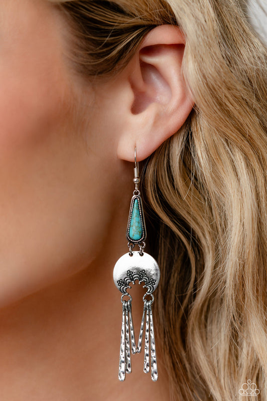Highland Haute - Blue and Silver Earrings - Paparazzi Accessories - A turquoise stone pressed in a studded triangular fitting, and a silver floral-decorated half moon frame link into an earthy lure. A collection of daintily textured silver tassels in varying sizes swing from the bottom of the stacked frame for a whimsical finish. Earring attaches to a standard fishhook fitting.