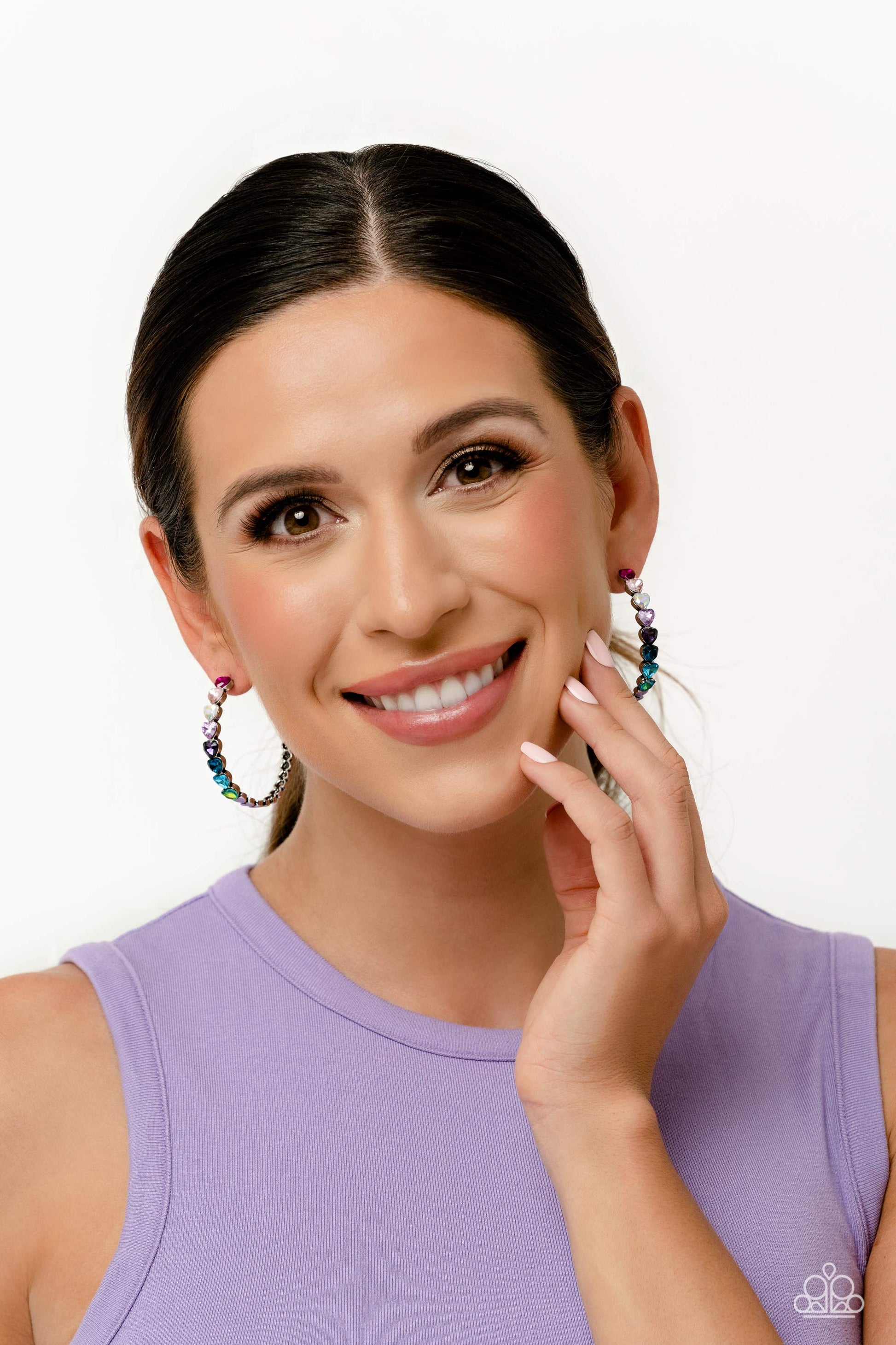 Hypnotic Heart Attack - Multi Heart Hoop Earrings - Paparazzi Accessories - Featuring a scalloped heart frame, glittery heart rhinestones in shades of pink, iridescence, purple, blue, and a refracted green shimmer slowly decrease in size as they curve down the ear to meet dainty silver hearts for a romantic statement. Earring attaches to a standard post fitting. Hoop measures approximately 1 3/4" in diameter.