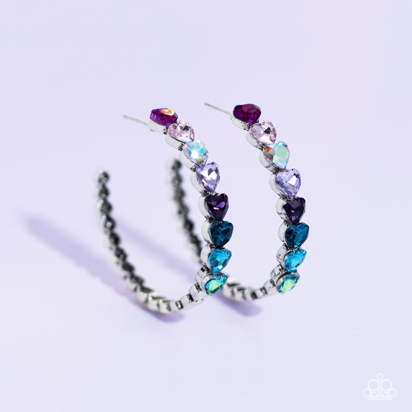 Hypnotic Heart Attack - Multi Heart Hoop Earrings - Paparazzi Accessories - Featuring a scalloped heart frame, glittery heart rhinestones in shades of pink, iridescence, purple, blue, and a refracted green shimmer slowly decrease in size as they curve down the ear to meet dainty silver hearts for a romantic statement. Earring attaches to a standard post fitting. Hoop measures approximately 1 3/4" in diameter.