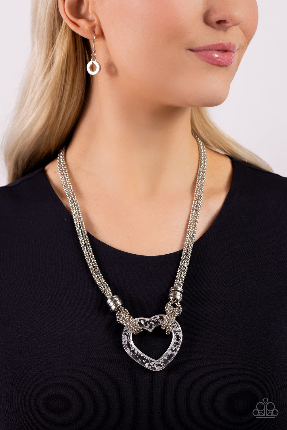 Lead with Your Heart - Silver Necklace - Paparazzi Accessories - Featuring a double-layered display of silver popcorn chain, a silver-flecked clear acrylic heart frame cascades down the neckline. Infused atop the acrylic heart, a trio of high-sheen silver rings adorns the layered chains for an industrial finish.