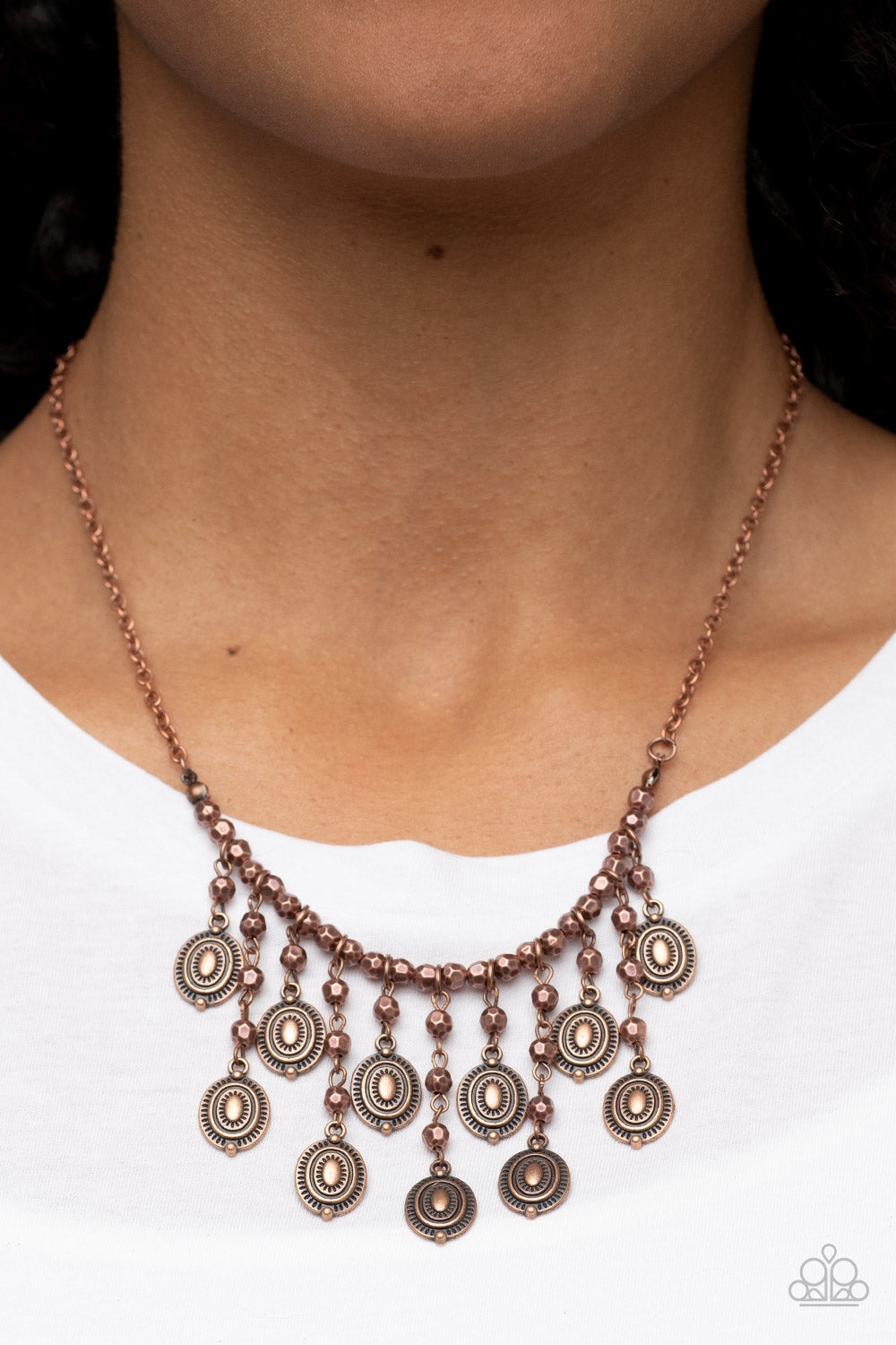 Leave it in the PASTURE - Copper Necklace - Paparazzi Accessories - Attached to an antiqued copper chain, a strand of faceted copper beads are threaded along an invisible wire below the collar. The gritty beads give way to a copper beaded tassel featuring textured copper frames, resulting in a rustic fringe below the collar.