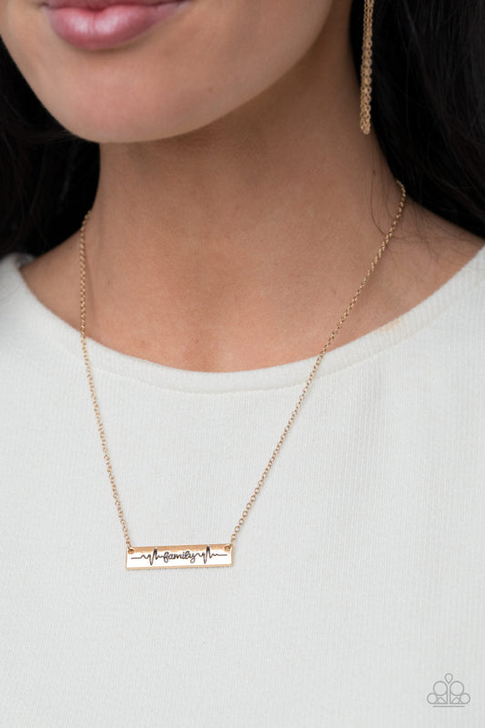 Living The Mom Life - Gold Necklace - Paparazzi Accessories - The word "Family," is inscribed between symbolic life lines on a shining rectangular gold plate creating an affectionate keepsake on a dainty gold chain below the collar.