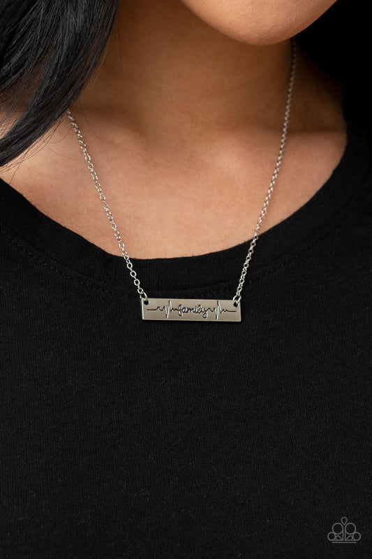 Living The Mom Life - Silver Necklace - Paparazzi Accessories - The word "Family," is inscribed between symbolic life lines on a rectangular silver plate creating an affectionate keepsake on a dainty silver chain below the collar. Features an adjustable clasp closure.