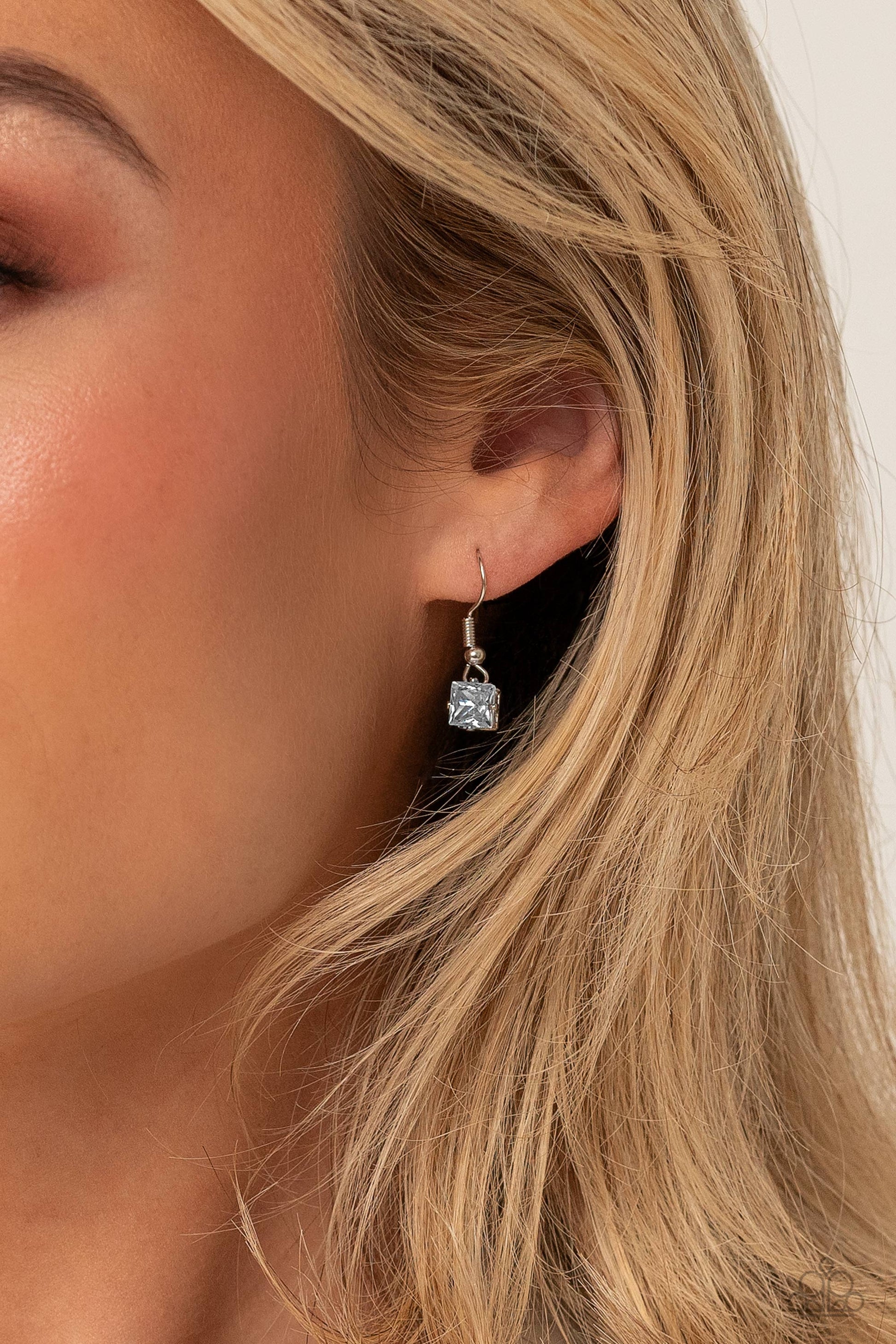 Lustrous Layers - White and Silver Necklace - Paparazzi Accessories - Featuring a subtle iridescent finish, exaggerated, faceted round, square, and teardrop gems layer down the chest from three sleek silver dainty chains, in a refined fashion.