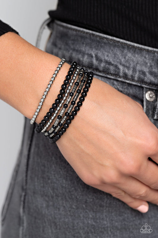 Mythical Magic - Black and Silver Bracelet - Paparazzi Accessories - A trendy collection of black, silver and silver cylindrical textured beads wrap around the wrist on elastic stretchy bands for a colorful, seasonal stack. Sold as one set of six bracelets.