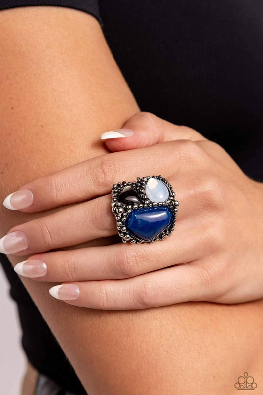 Natural Motley - Blue Ring - Paparazzi Accessories - Set in an exaggeratedly silver studded frame, a blue lapis, gray, and white resin opal in various shapes coalesce atop the finger for a natural display. Features a stretchy band for a flexible fit.
