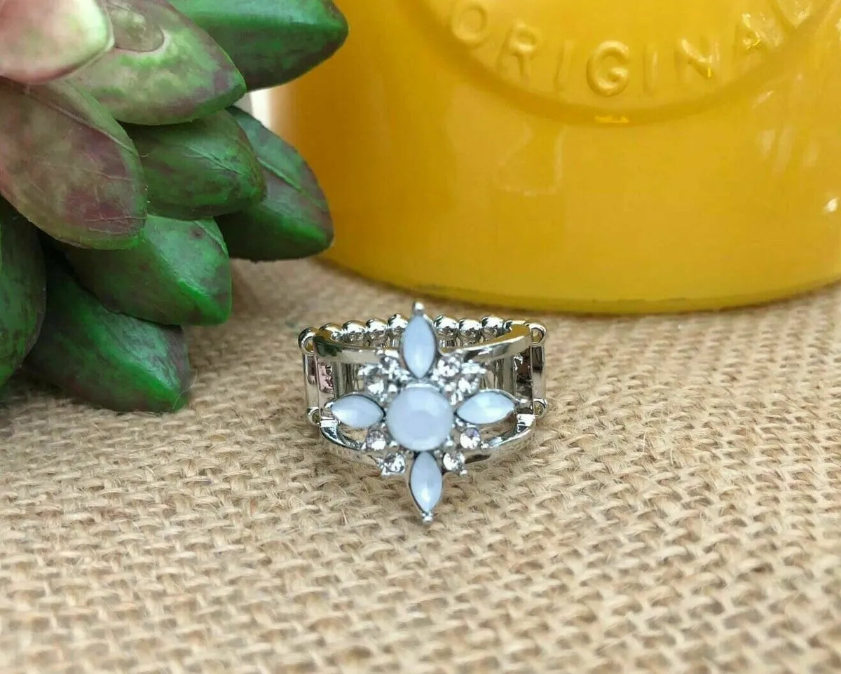 Opal Orchards - White and Silver Ring - Paparazzi Accessories - Infused with dainty white rhinestones, marquise and round cut opal rhinestones join into a flowery centerpiece atop layered silver bands for an enchanting sparkle. Features a stretchy band for a flexible fit. Sold as one individual ring.