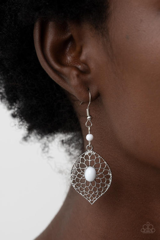 Perky Perennial - White and Silver Earrings - Paparazzi Accessories - Airy silver petals bloom from an oval white beaded center at the bottom of a solitaire white bead, resulting in a whimsical floral lure. Earring attaches to a standard fishhook fitting. Sold as one pair of earrings.