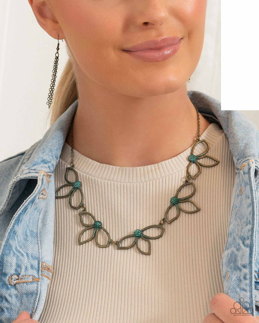 Petal Pageantry - Brass Necklace - Paparazzi Accessories - Featuring patina-brushed centers, dainty brass petals delicately link together and fan out below the collar for a whimsical fashion.