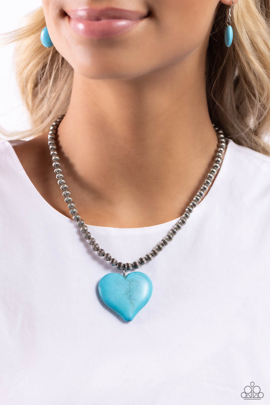 Picturesque Pairing - Blue Turquoise and Silver Heart Necklace - Paparazzi Accessories - An oversized turquoise stone heart pendant swings from the bottom of a textured silver beaded display below the collar for a flirtatiously earthy fashion.