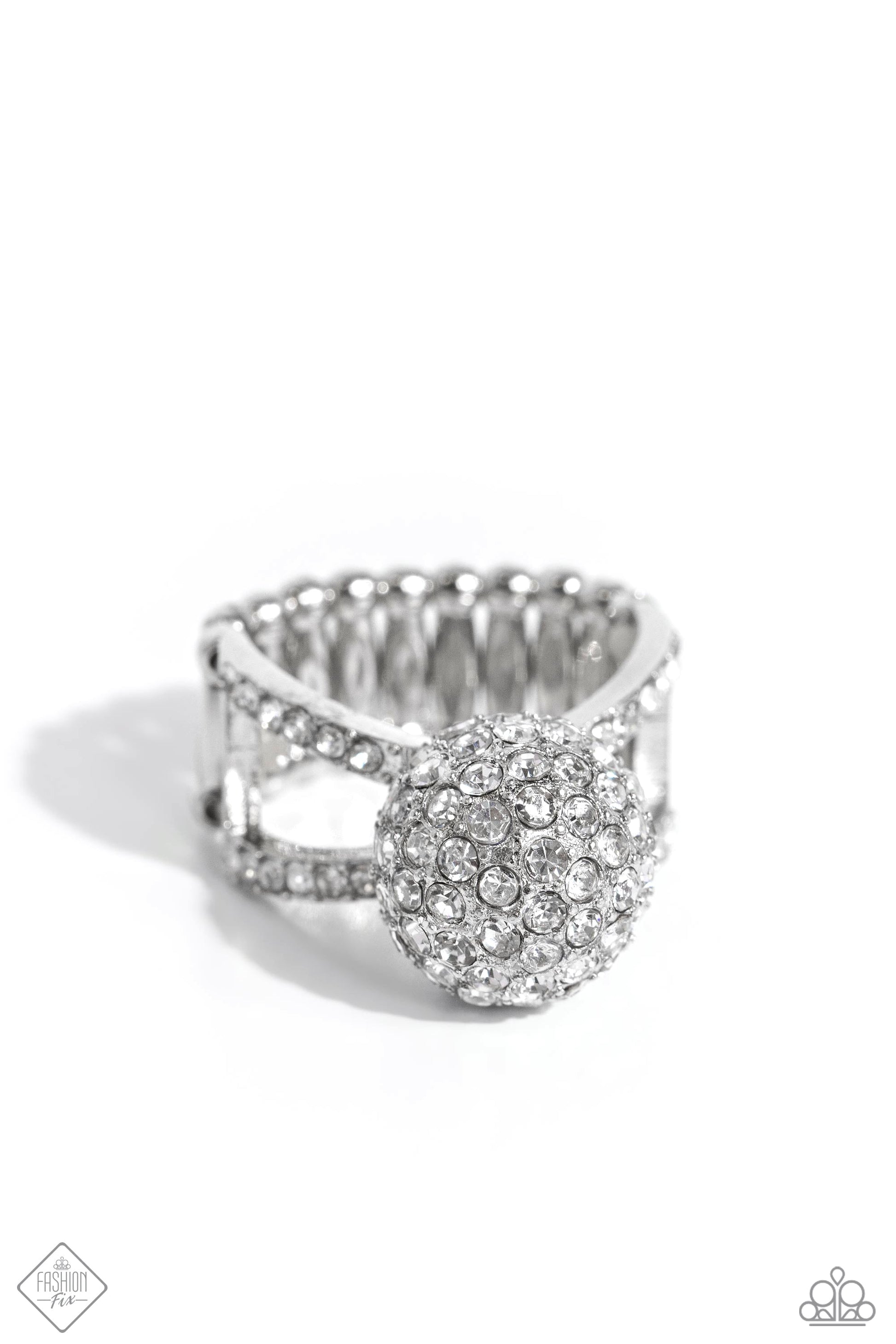 Polished Pageant - White and Silver Ring - Paparazzi Accessories - Dotted in dainty white rhinestones, blinding silver frames delicately crisscross across the finger for a dramatic sparkle. Featured in the center of the sparkly, airy bands, an elevated rhinestone-encrusted silver ornament creates a blinding statement atop the finger. Features a stretchy band for a flexible fit. Sold as one individual ring.