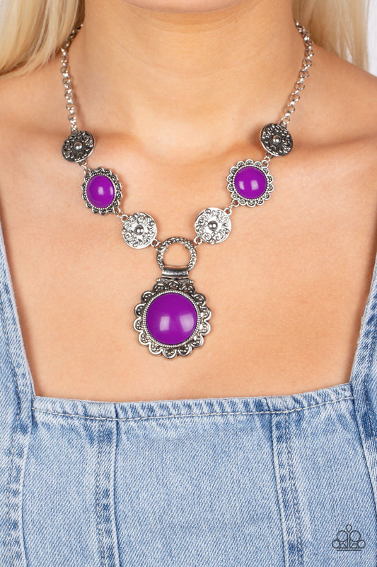 Poppy Persuasion - Purple and Silver Necklace - Paparazzi Accessories - Shiny oversized Dahlia beads are wrapped in floral-inspired frames of silver, filled with studded texture. Silver discs embossed in a filigree motif alternate with the vibrant beads as they link along the collar, with a larger version of the Dahlia accents dropping below to create a whimsical pendant.