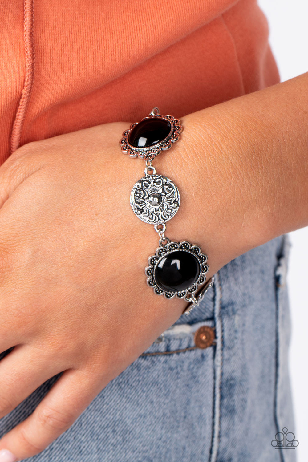 Positively Poppy - Black Bracelet - Paparazzi Accessories - Shiny oversized black beads are wrapped in floral-inspired frames of silver, filled with studded texture. Silver discs embossed in a filigree motif alternate with the vibrant beads as they link around the wrist in a whimsical finish.
