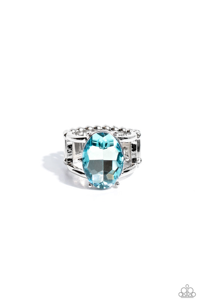 Prismatically Pronged - Blue Gem Ring - Paparazzi Accessorie- Paparazzi Accessories - Silver pronged fittings coalesce around a light blue oval gem splashed in a prismatic shimmer atop the center of an airy silver band, resulting in a refined centerpiece atop the finger. Features a stretchy band for a flexible fit. Sold as one individual ring.