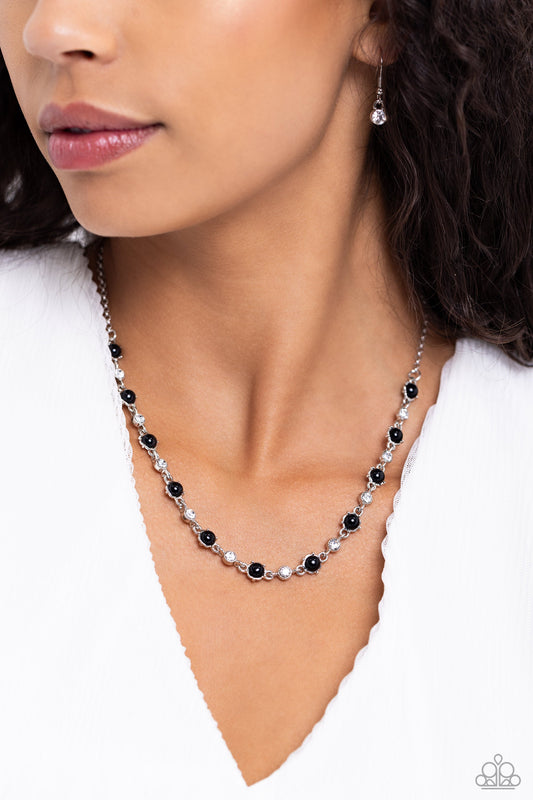 Pronged Passion - Black and Silver Necklace - Paparazzi Accessories - Encased in pronged silver frames, round black beads and white gems delicately connect and alternate below the collar on a dainty silver chain for a seasonal flair.