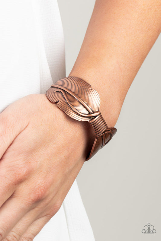 Quill Quencher - Copper Cuff Bracelet - Paparazzi Accessories - Infused with faux metal laces, an oversized copper feather asymmetrically curls around the wrist for a whimsical Southwestern vibe.