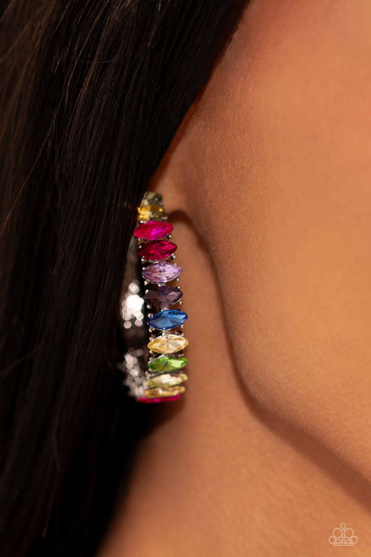 Rainbow Range - Multi Color Hoop Earrings - Paparazzi Accessories - Dazzling colorful marquise-cut gems fall in line along the front edge of a classic silver hoop. The exposed edges create a gritty silhouette, beautifully contrasting with the blinding shimmer of the gems in a stunning finish. Earring attaches to a standard post fitting. Hoop measures approximately 1 1/2" in diameter. Sold as one pair of hoop earrings.