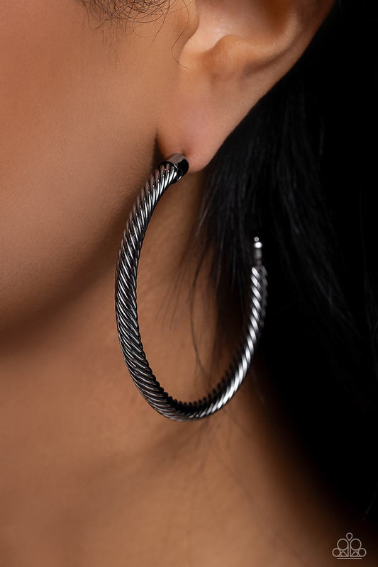 Roped in Radiance - Black Gunmetal Hoop Earrings  - Paparazzi Accessories - Shimmering gunmetal spins into an oversized twisted rope as it curves into a classic thick hoop design. Earring attaches to a standard post fitting. Hoop measures approximately 2" in diameter. Sold as one pair of hoop earrings.