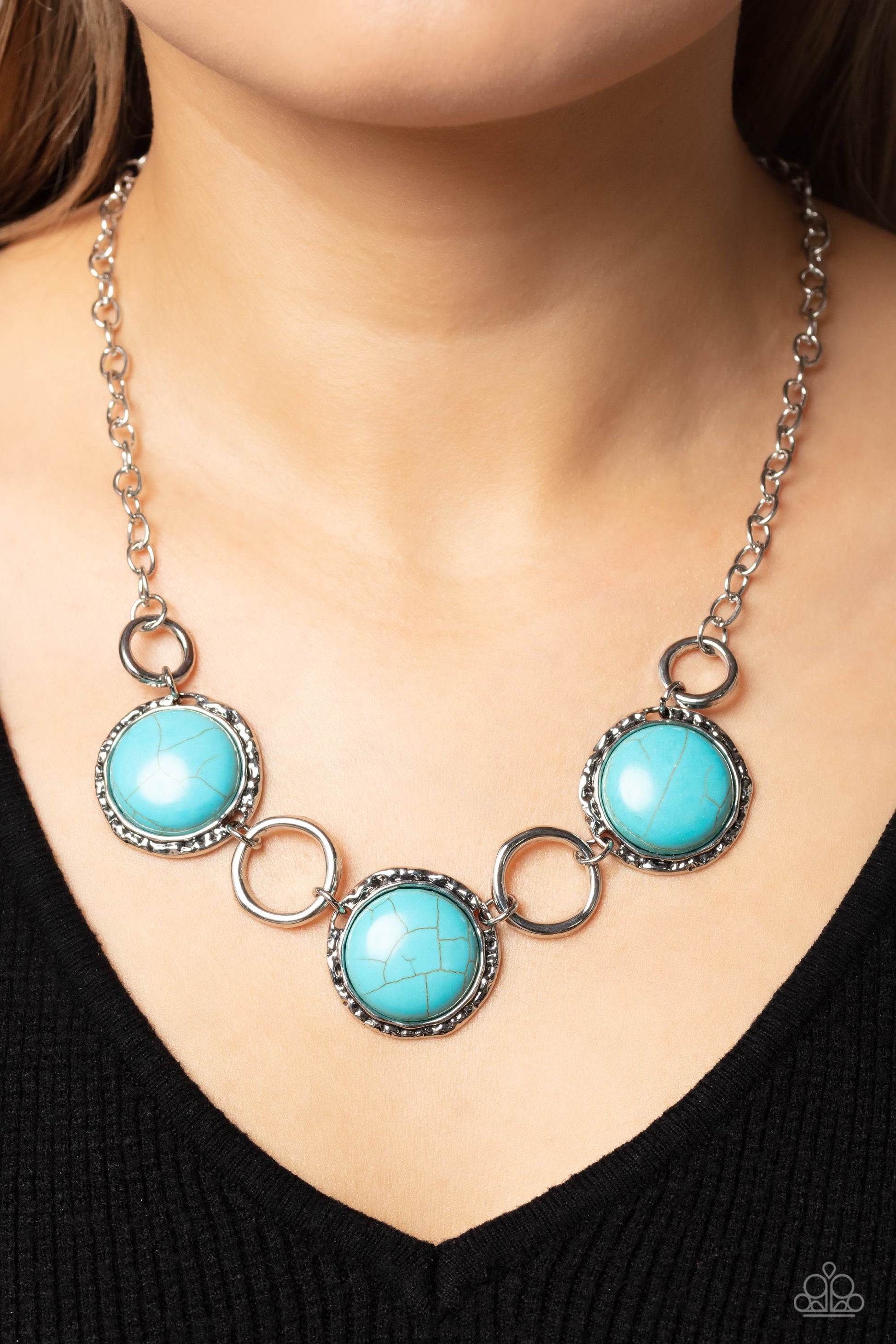 Saharan Scope - Blue Turquoise and Silver Necklace - Paparazzi Accessories - Warped silver hoops in varying sizes alternate along hammered silver frames. Pressed into the hammered frames, oversized turquoise stones add a vibrant, earthy flair to the summery palette. Features an adjustable clasp closure.