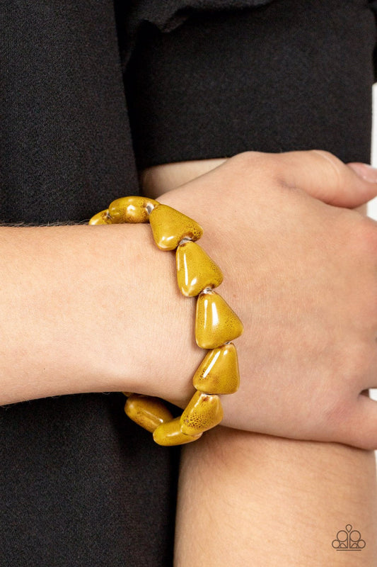 SHARK Out of Water - Yellow Bracelet - Paparazzi Accessories - Painted in a distressed Mustard finish, ceramic beads shaped like shark teeth are threaded along a stretchy band around the wrist for a seasonal flair.