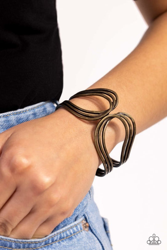 Shockwave Attitude - Brass Bracelet - Paparazzi Accessories - Featuring a rustic finish, flat brass bars delicately loop and overlap into two airy brass frames around the wrist that delicately connect into a layered bangle-like bracelet. Features a hinged closure. Sold as one individual bracelet.